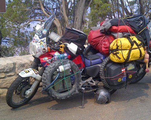 Motorbike loaded with panniers and a tank bag ready for a tour